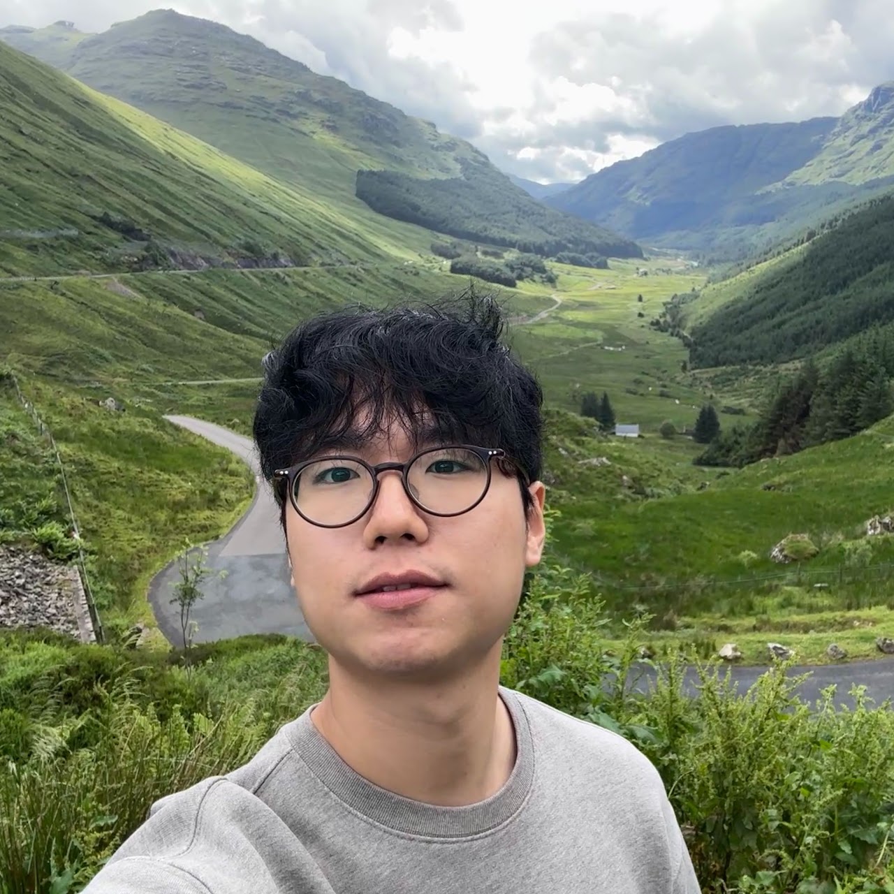 Hyunyoung Han in a green mountain valley
